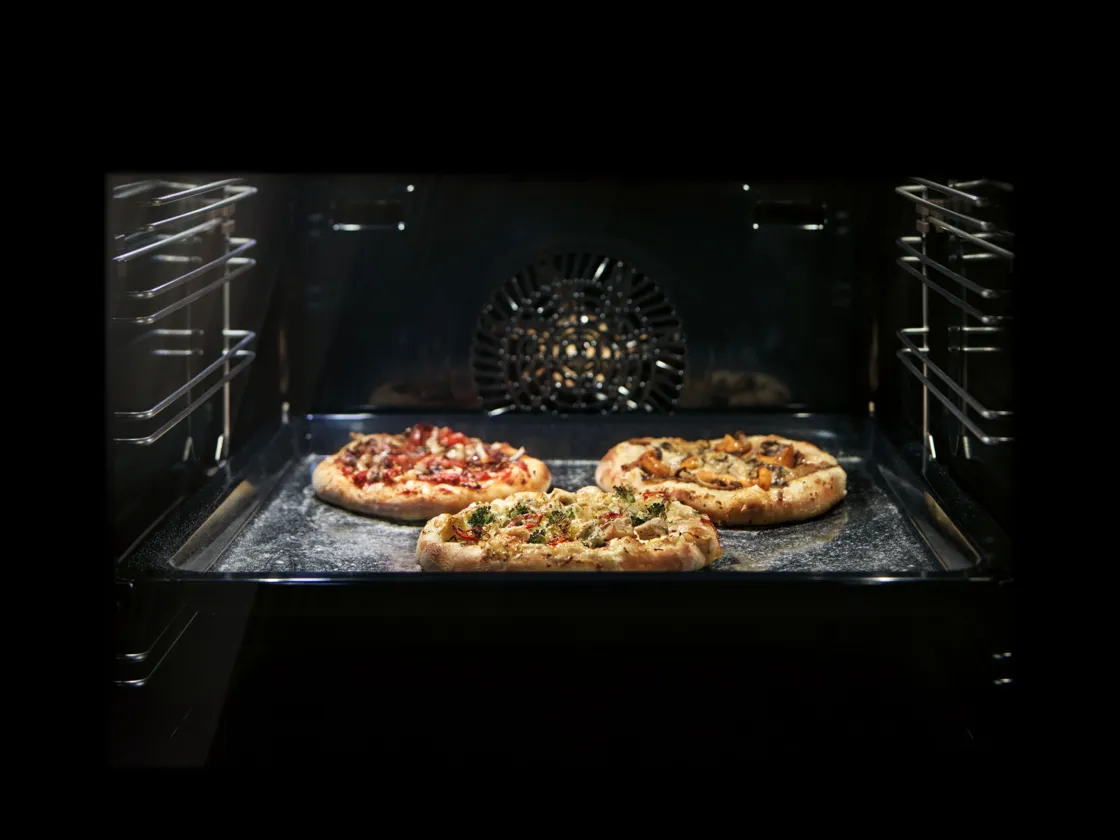 Pizzas cooking in oven