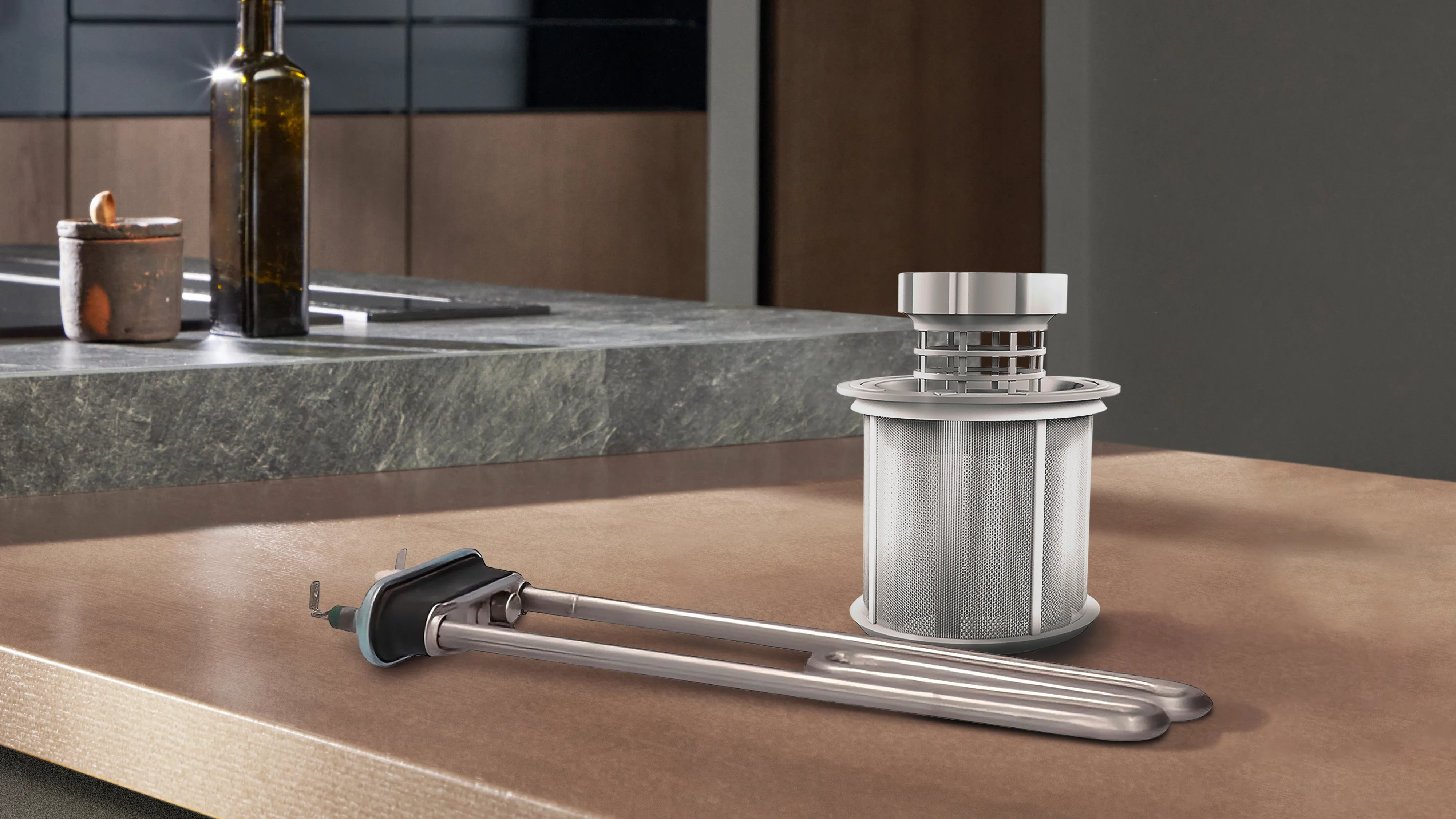 alt-A washing machine heating element and a dishwasher filter are placed on a wooden kitchen worktop near a sink.