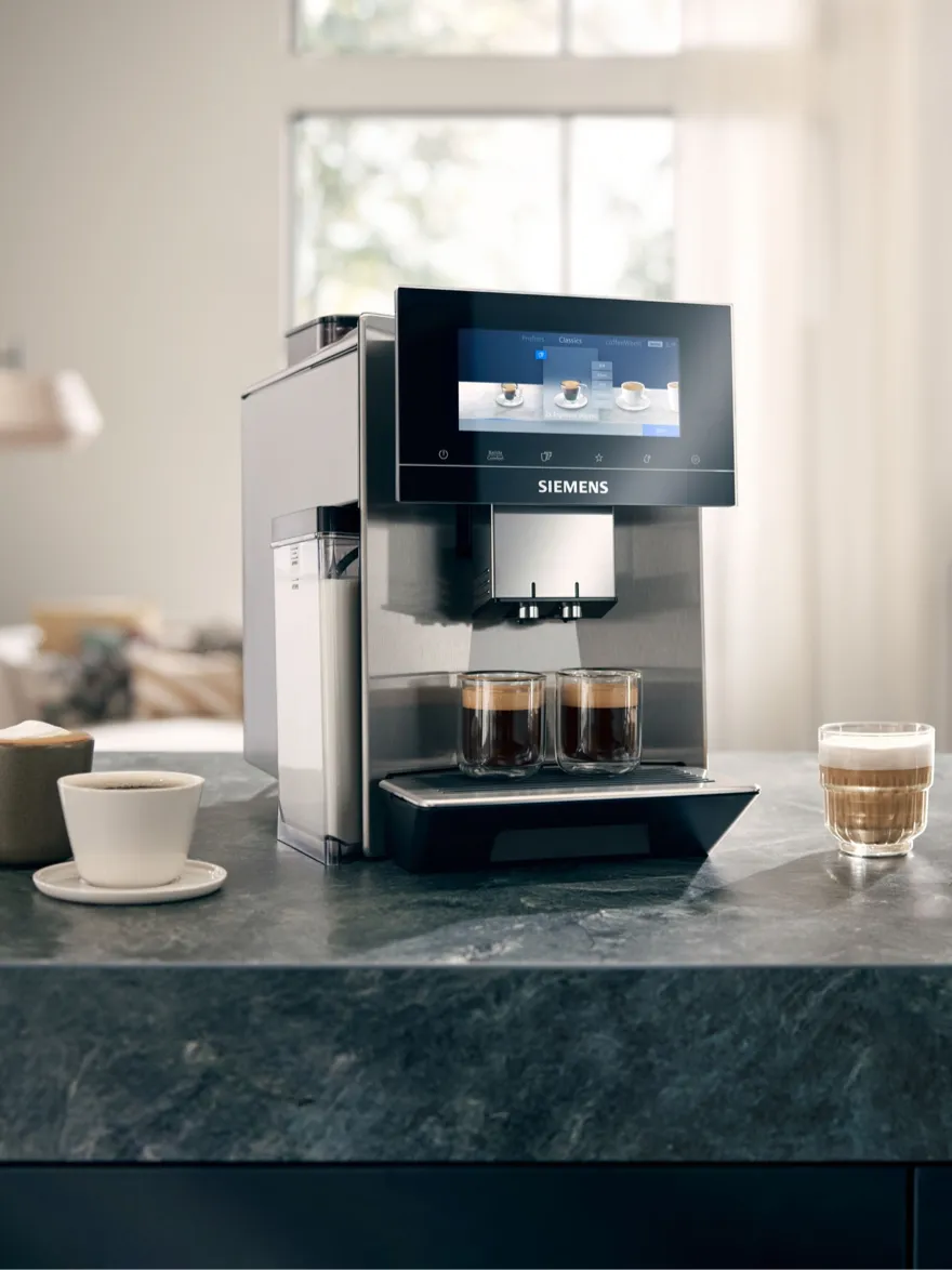 Siemens coffee machine on kitchen counter, two cups of coffee, modern and minimalist design.