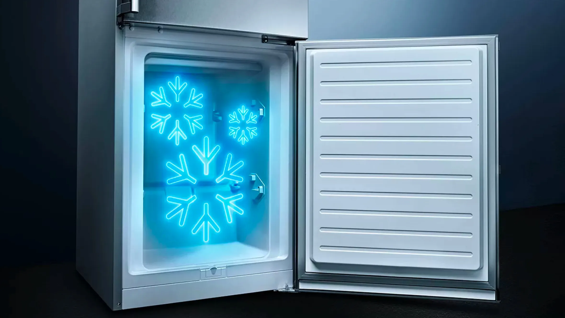 Freezer with illuminated snowflake design, open door revealing cold interior.