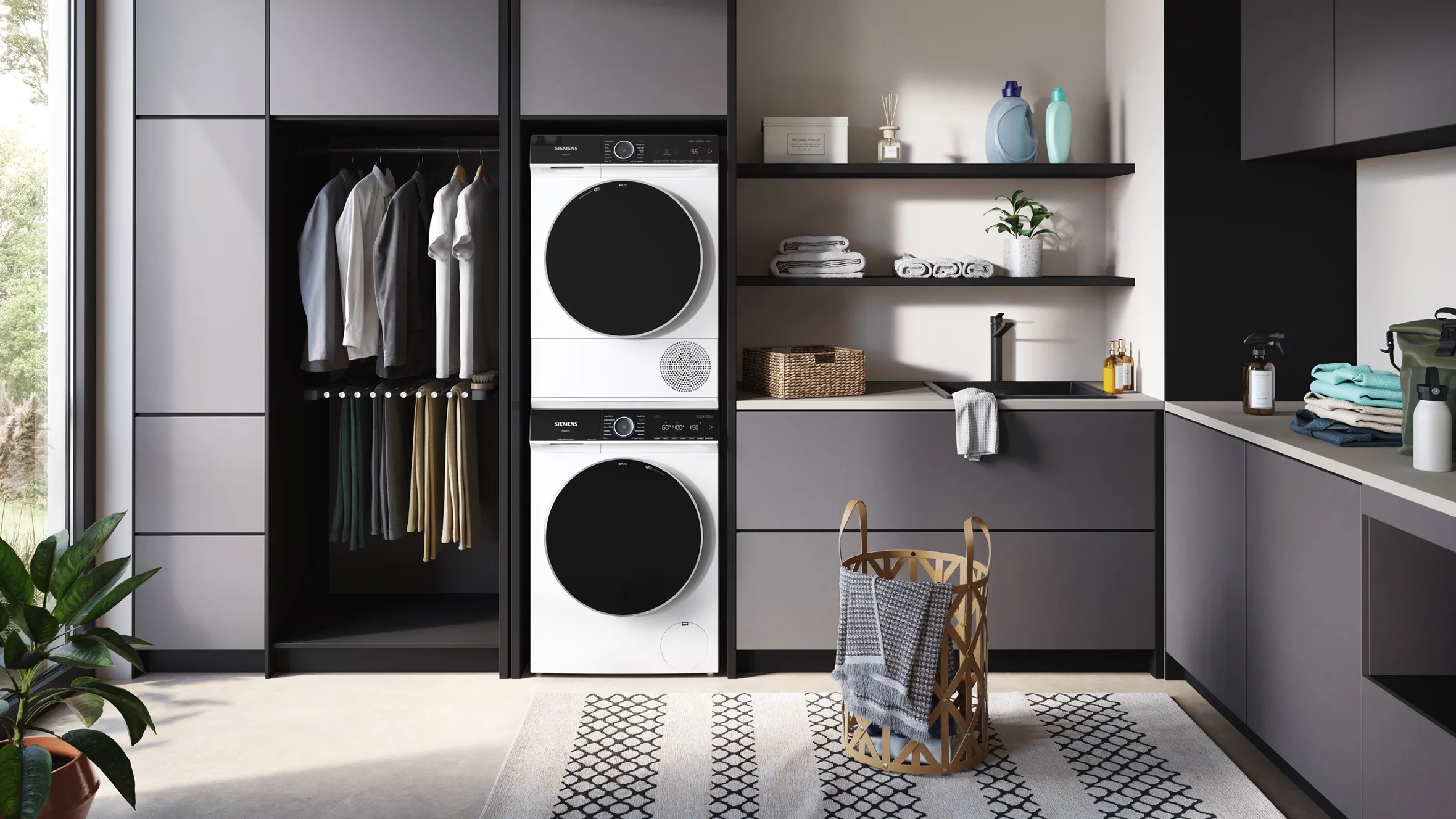 Minimalist laundry room with black cabinets, shelves, washer, dryer, and decorative accents.