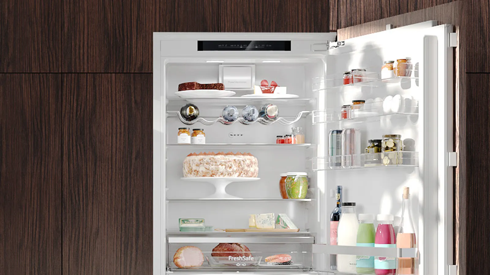 Open refrigerator with various food items, drinks, and kitchen accessories neatly organized on the shelves.