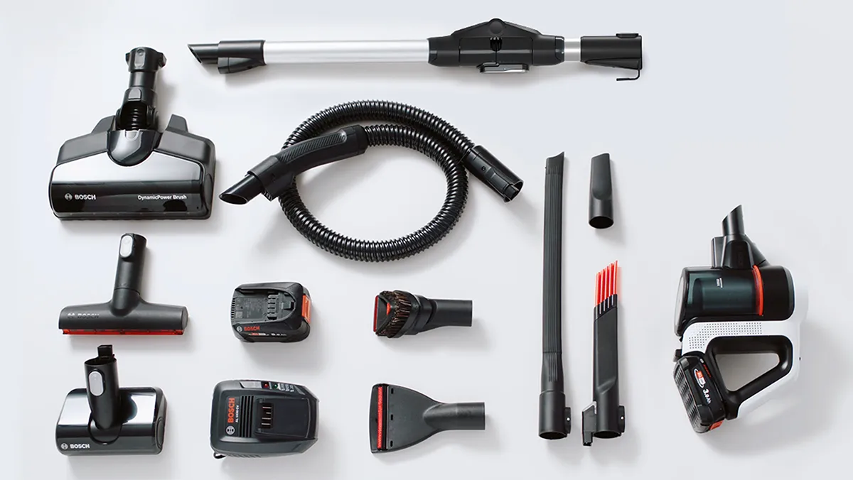 Vacuum cleaner accessories and attachments, including hose, brushes, and power tools, arranged on a white background.