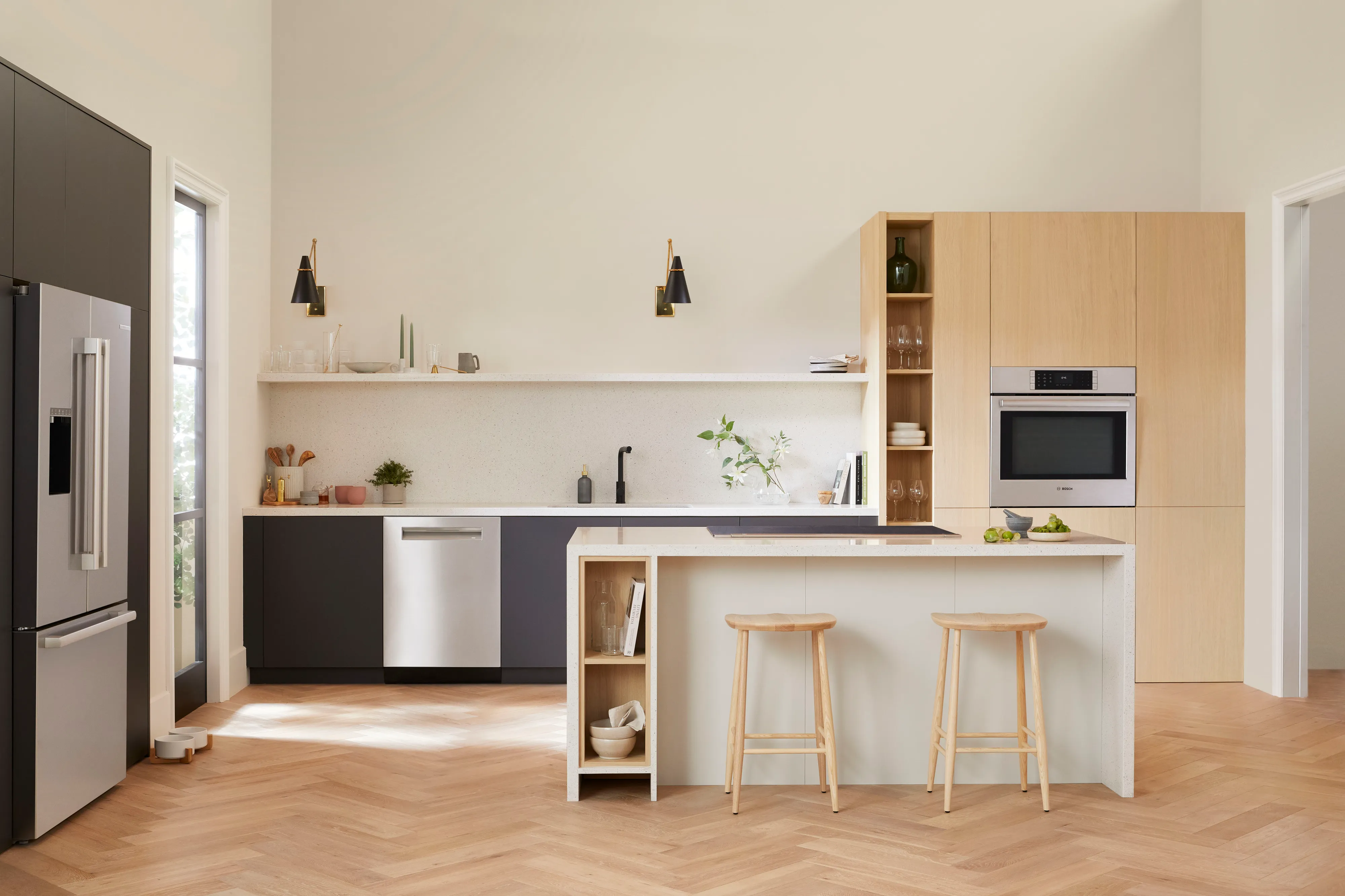 Bosch espresso machine on a kitchen counter with six different coffee drinks in various glasses and mugs.