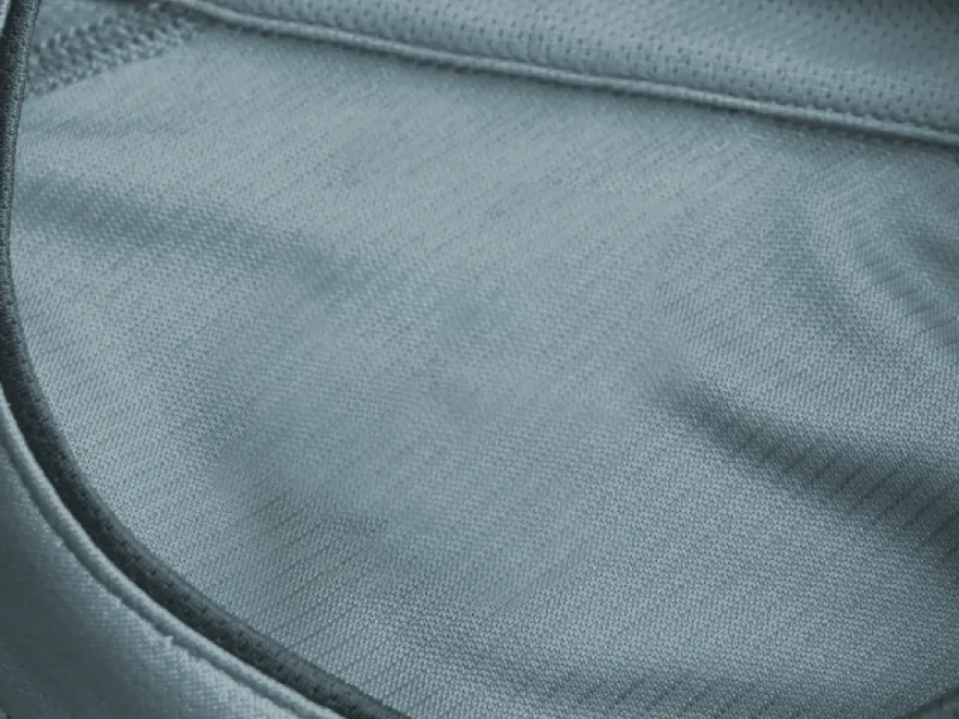 Closeup of soft, textured gray fabric with subtle patterns and folds.