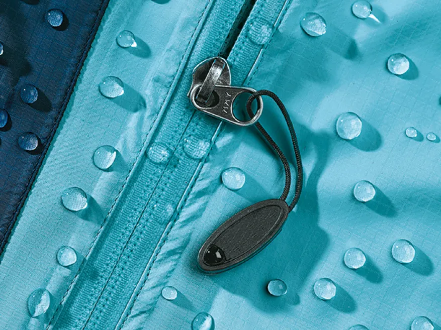 Turquoise raincoat fabric with water droplets, zipper, and metal zipper pull.