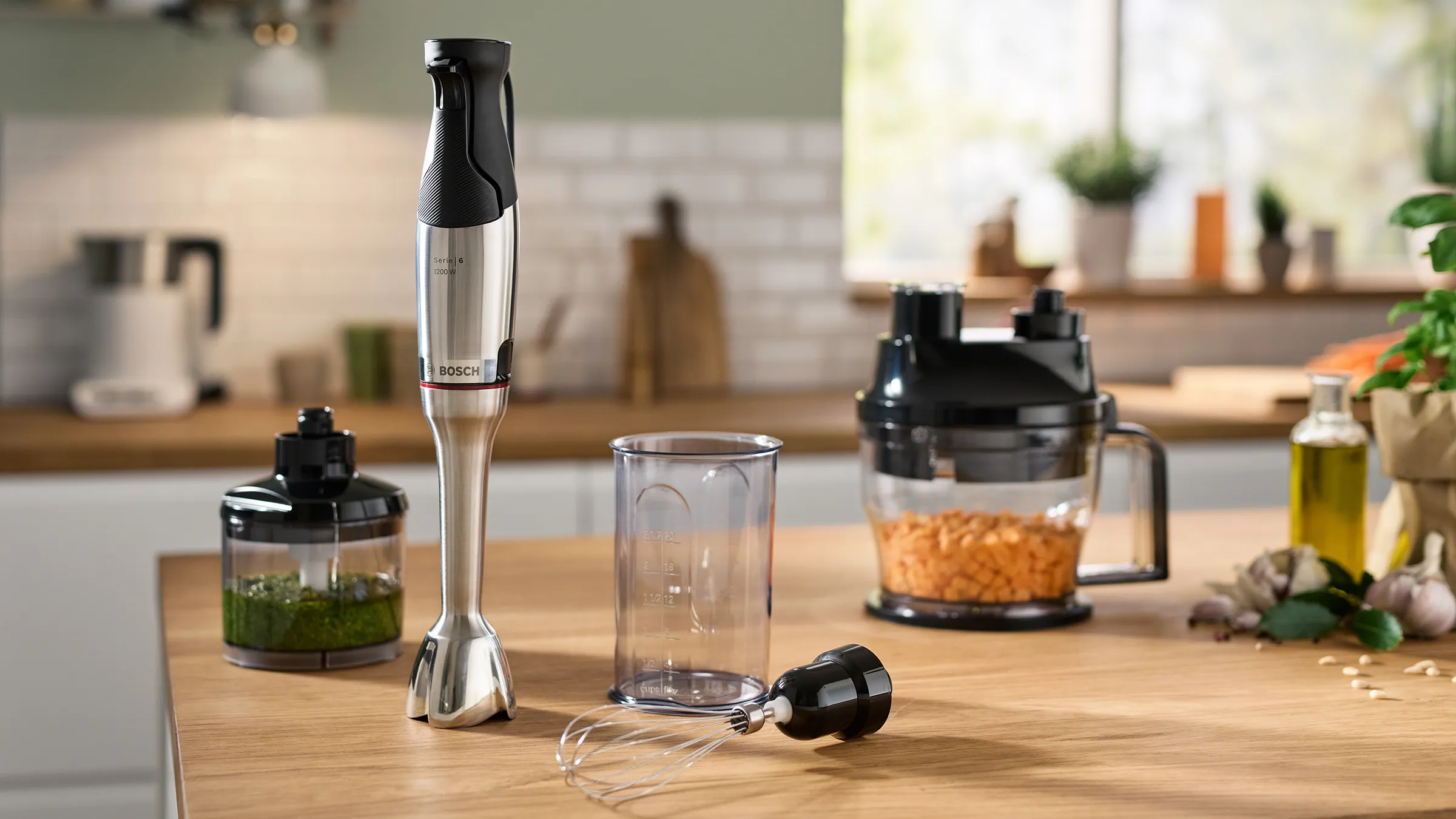 The ErgoMaster hand blender set with the attachments on a kitchen worktop.