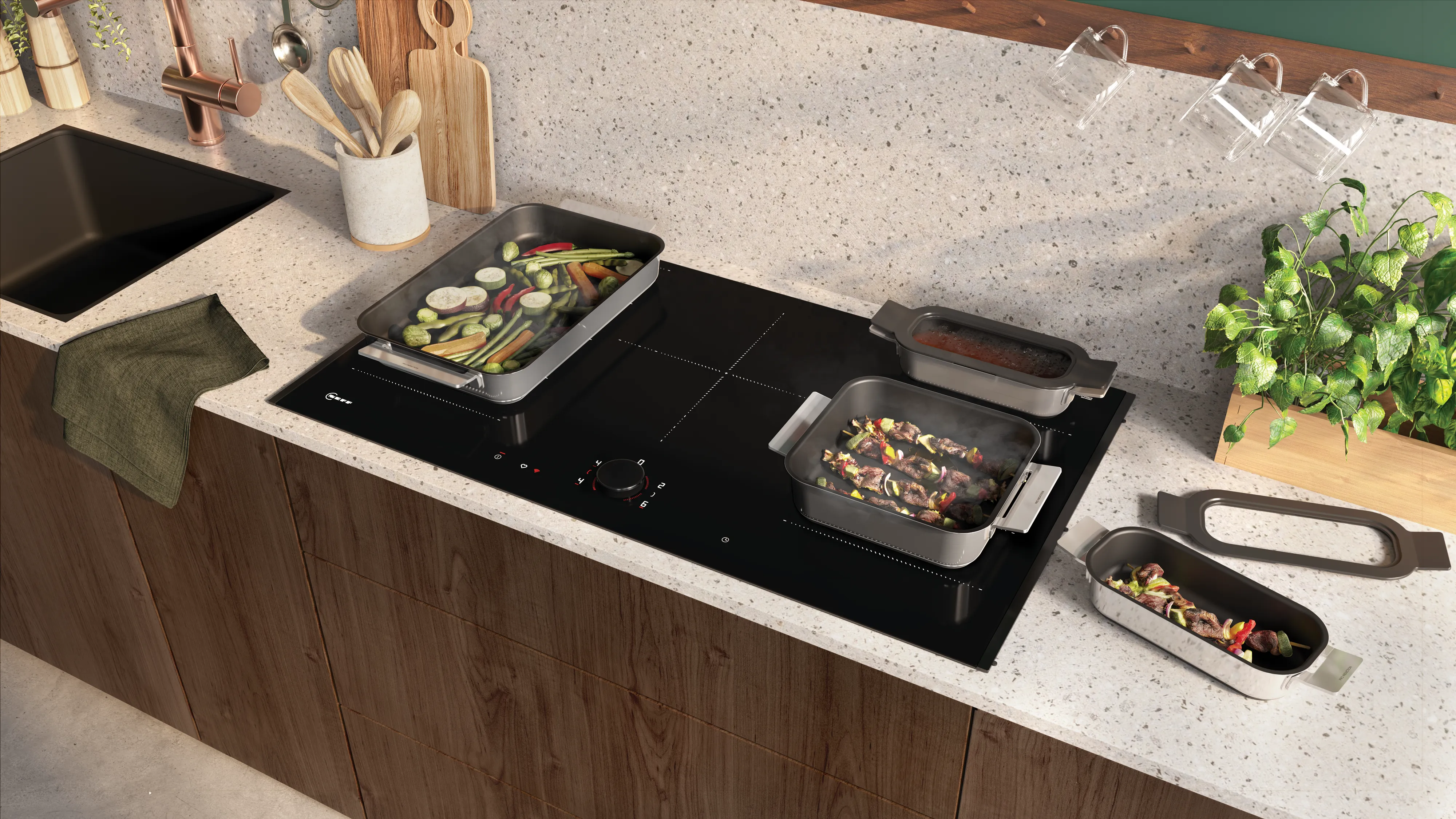 Comptoir cuisine avec appareils de cuisson, ustensiles et plantes.