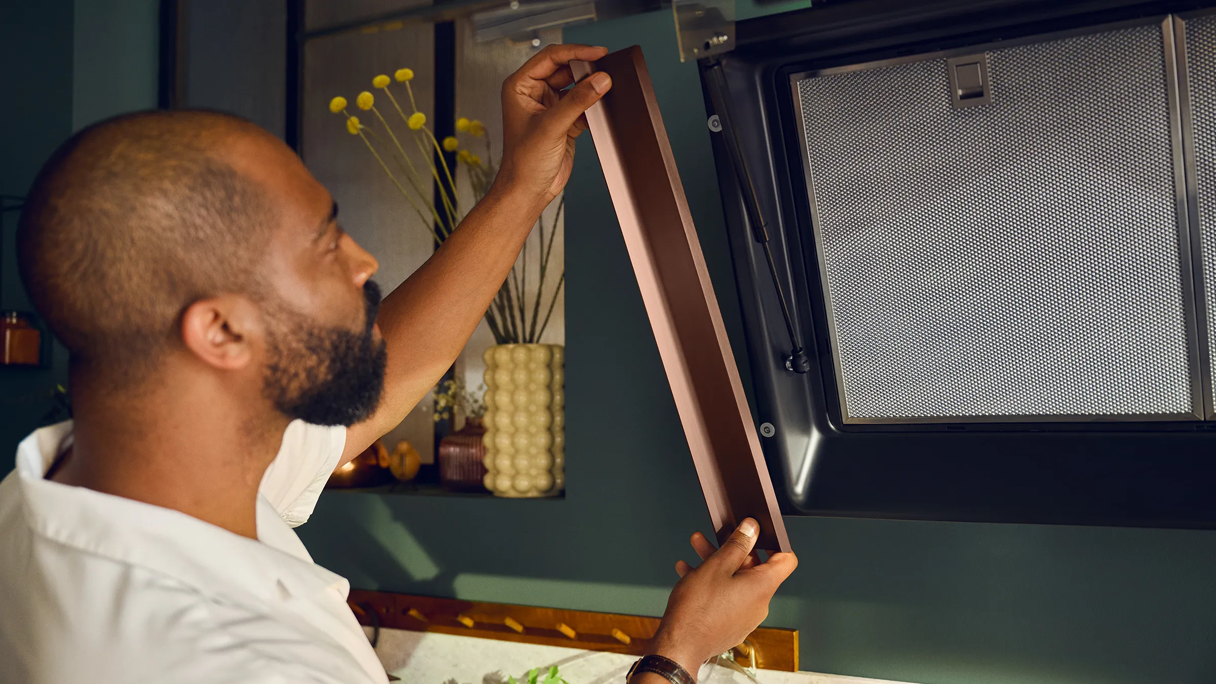 Man hanging framed flex design hood