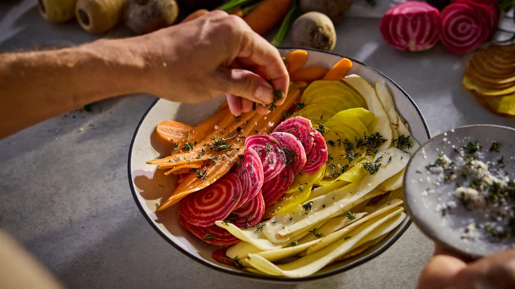 Colorful vegetable platter with sliced beets, carrots, and other roasted vegetables on a plate.