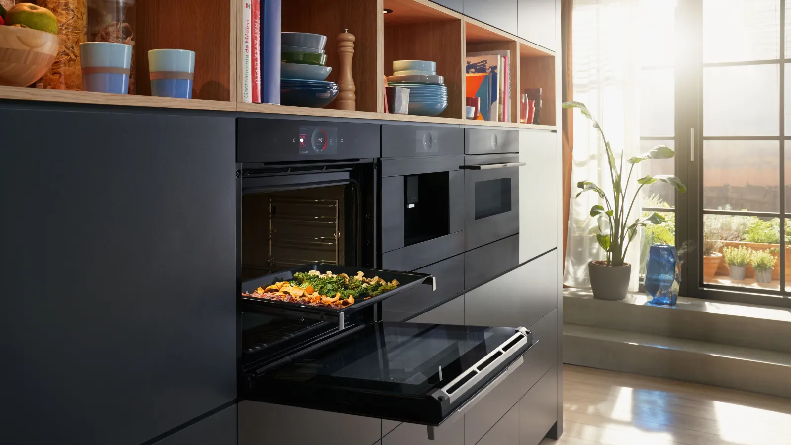 Modern kitchen with open shelves, oven, and vegetables on tray.