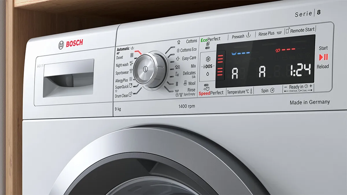Washing machine control panel with various settings and indicators, including temperature, spin speed, and time remaining.