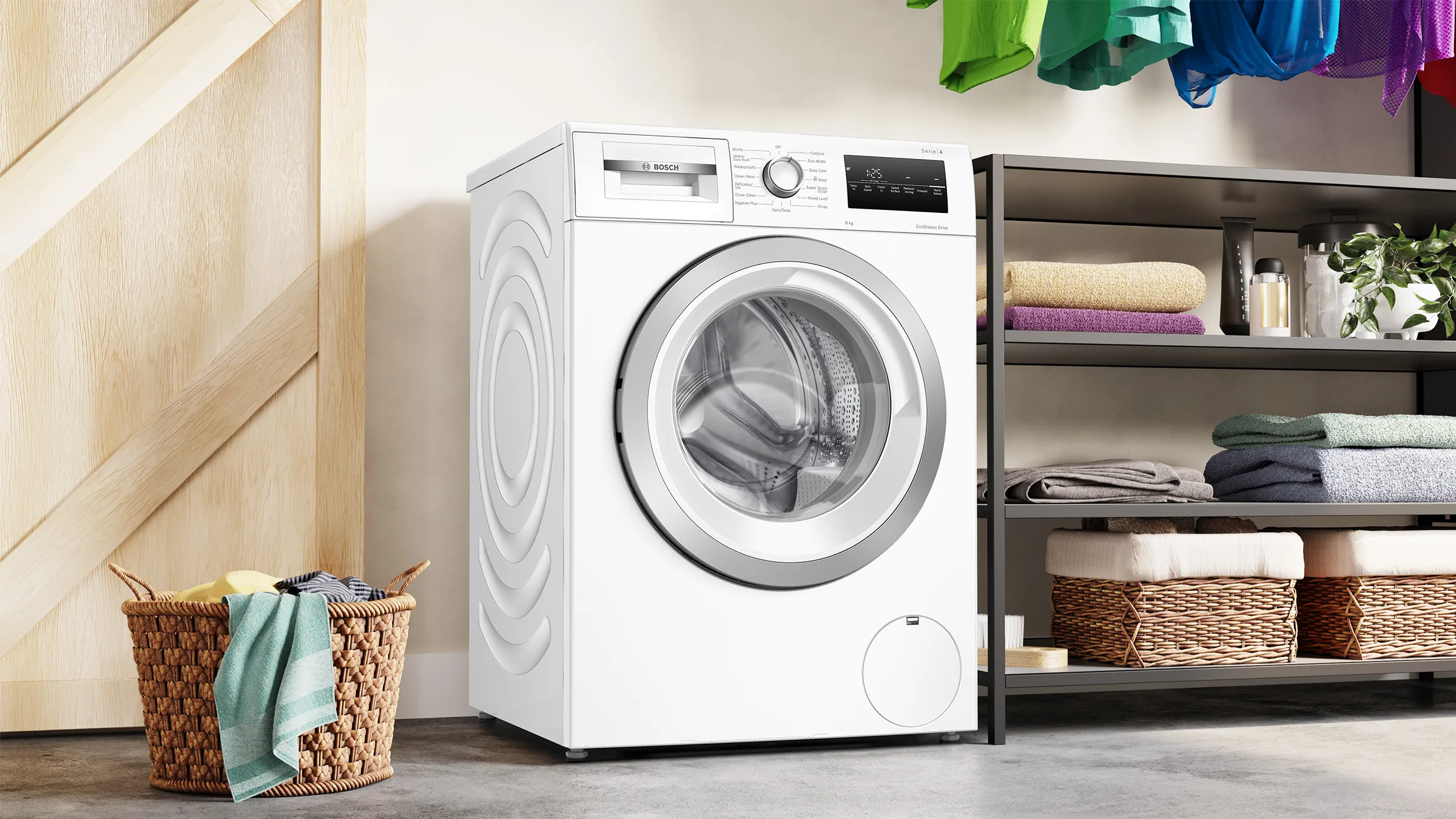 Washing machine, laundry baskets, shelves with folded clothes, wooden wall, modern appliance.
