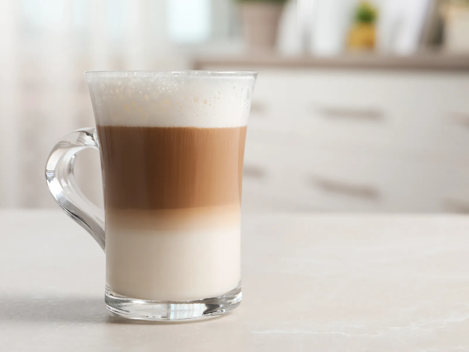 Large latte coffee on the kitchen counter.