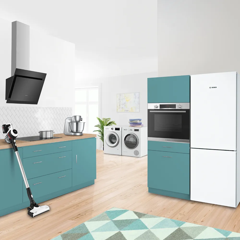 Modern kitchen with teal cabinets, white appliances, and hardwood floors.