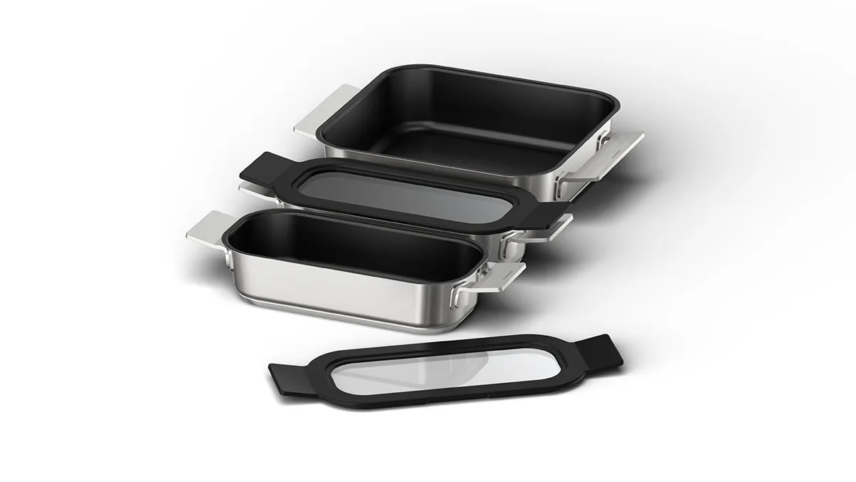 Stainless steel bakeware set with black nonstick interiors and removable handles.