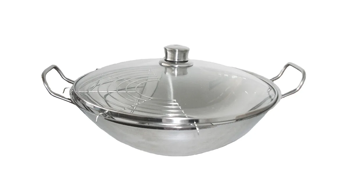Stainless steel wok with glass lid, featuring a spider-web-like pattern on the surface.