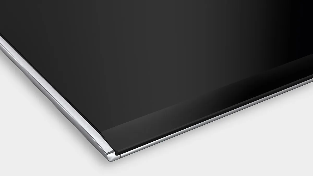Black glass surface with chrome trim, minimalist design.