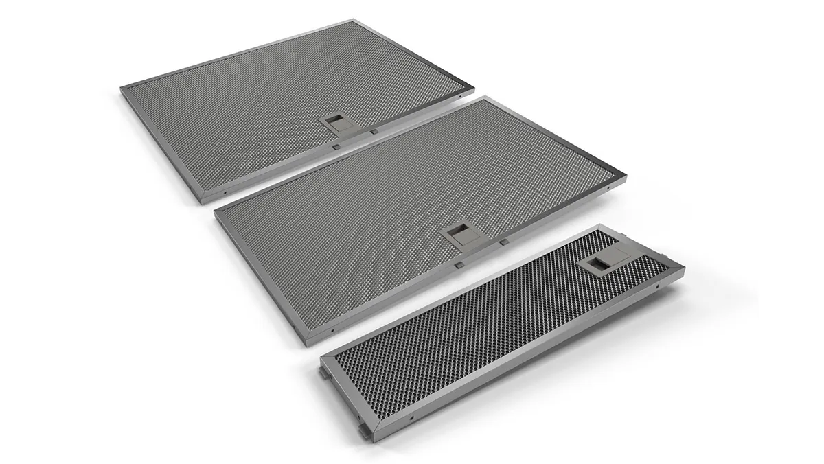 Three gray metal grills or filters of varying sizes arranged on a white background.