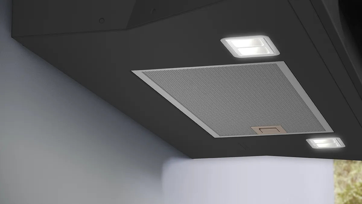Ceiling with recessed lighting and ventilation system in a dark room.