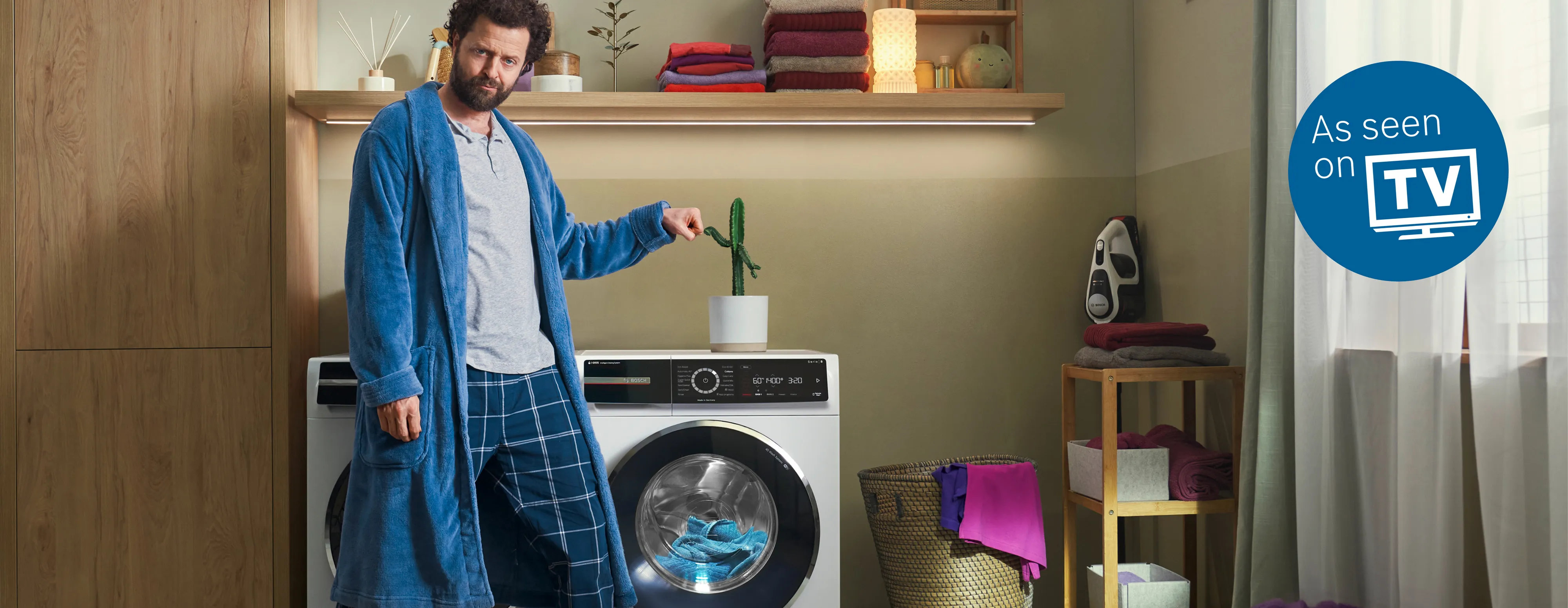 Bosch freestanding washer next to condense dryer in a modern laundry room.