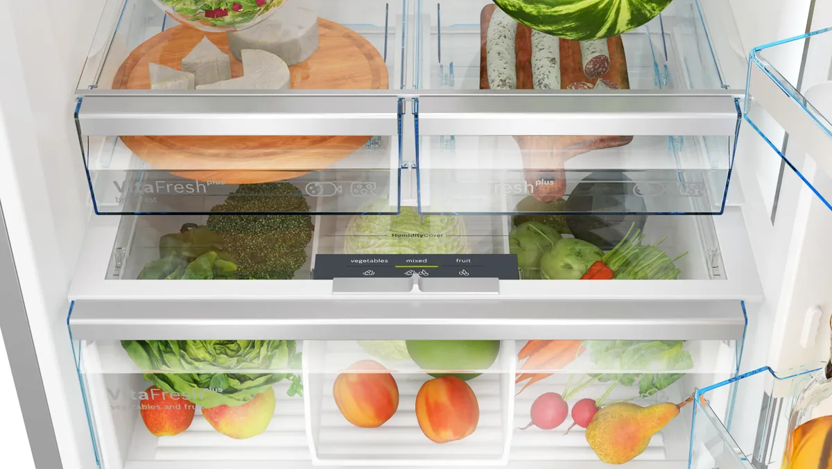 A well-organized refrigerator filled with fresh food, drinks, and condiments in storage containers.