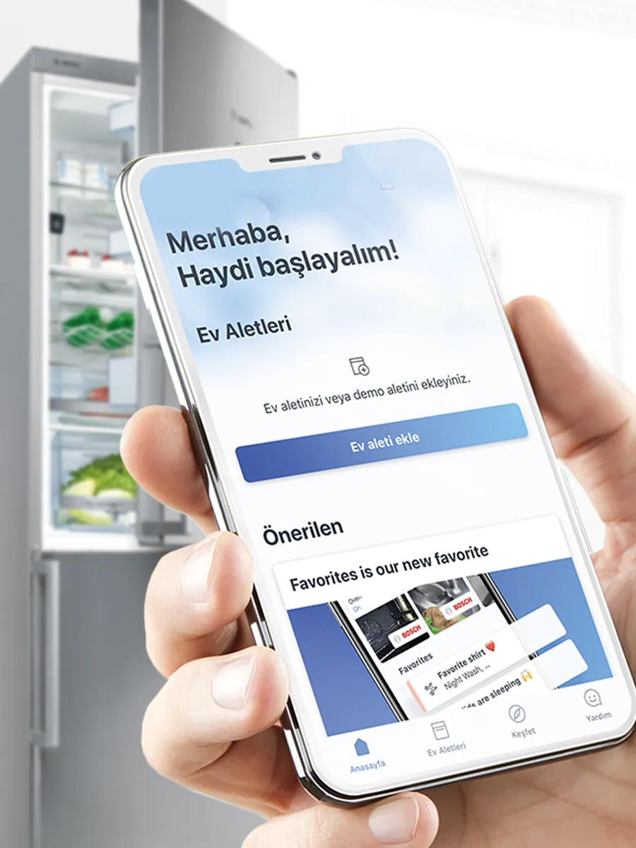 A hand holding a smartphone displaying a home appliance app, with options for controlling devices.