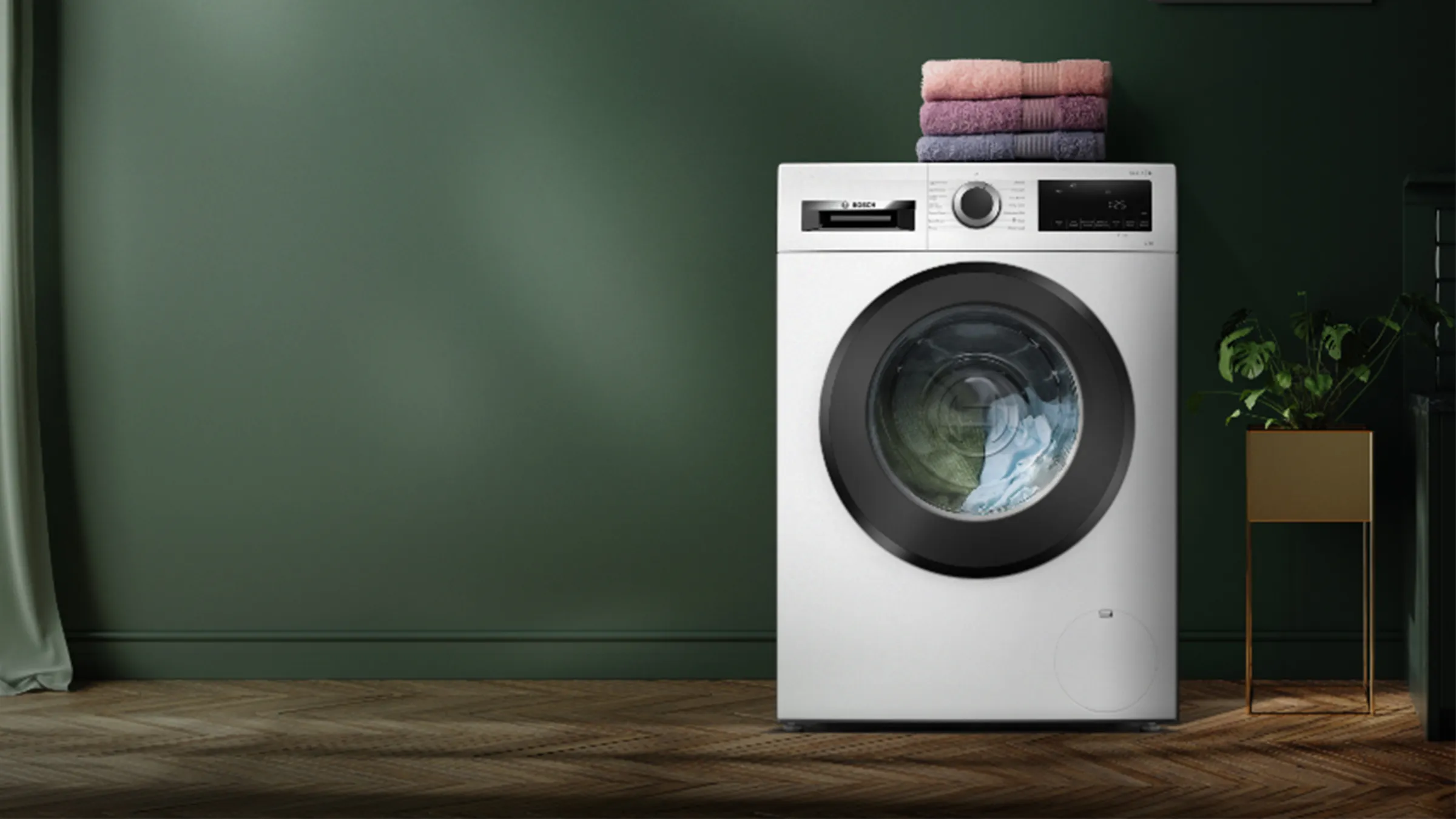 Washing machine with folded towels on top, in a minimalist home interior setting.