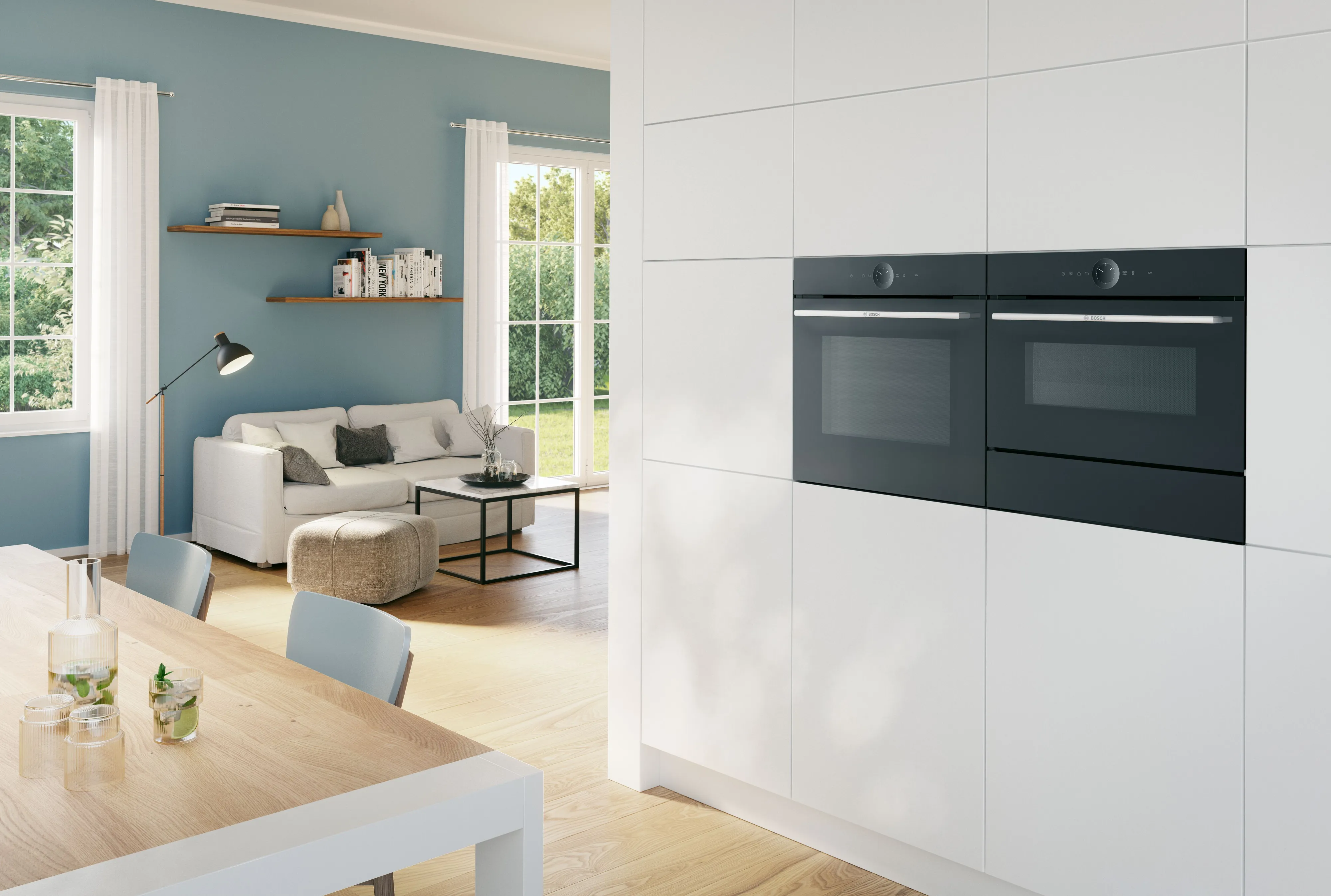 Pair of built in microwaves in white cabinets set in home