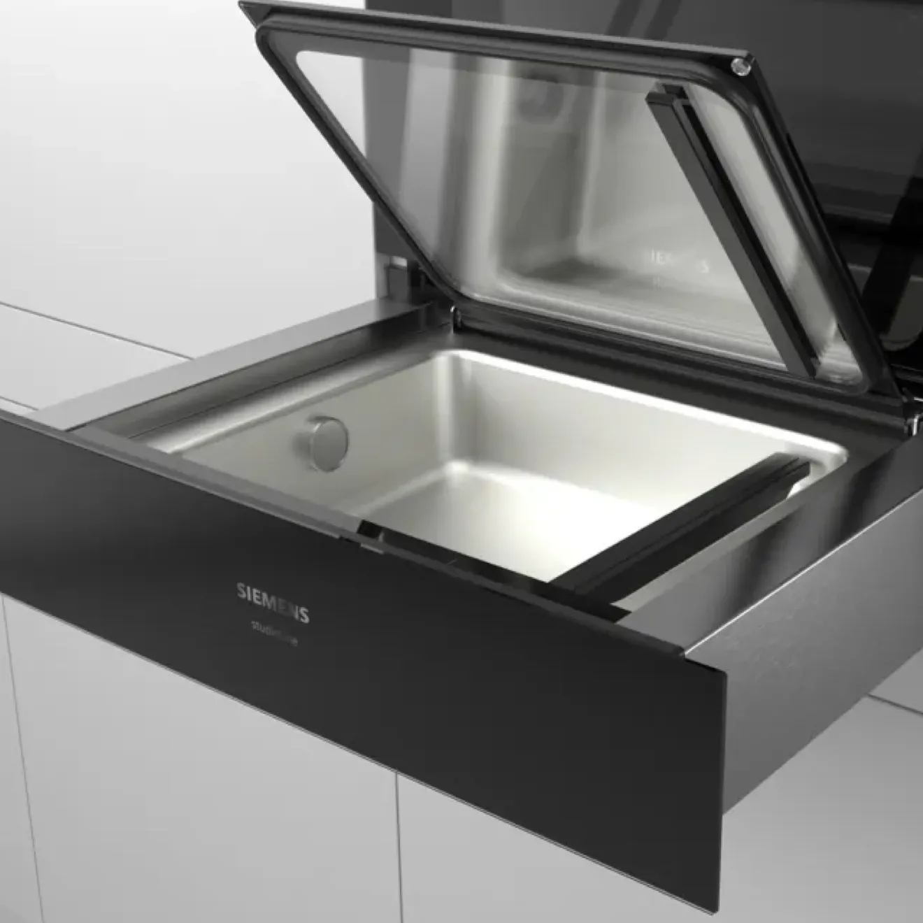 Stainless steel kitchen drawer with open lid, showcasing a storage compartment.
