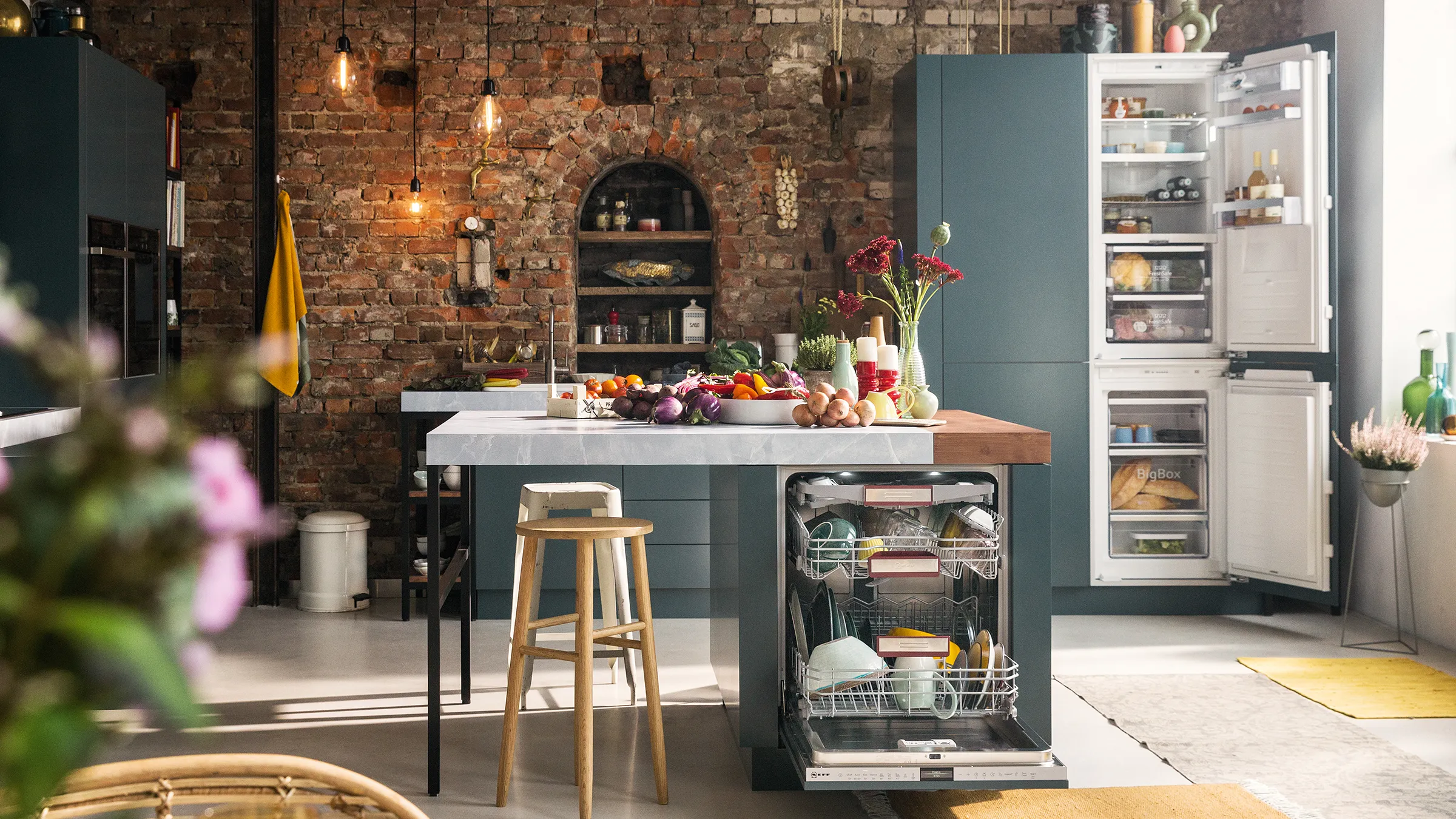 Rustic kitchen with brick walls, wooden table, kitchen island, and modern appliances.