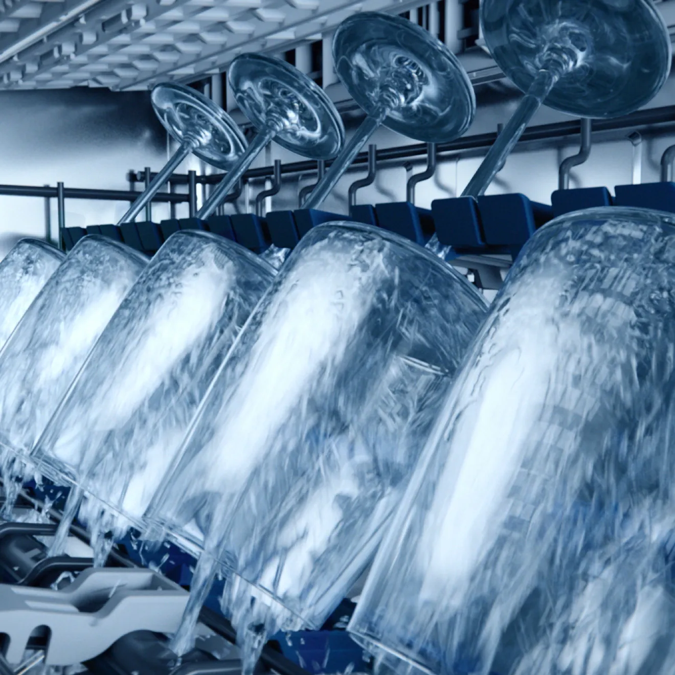 Rows of industrial washing machines with spinning drums, creating a dynamic water flow pattern.