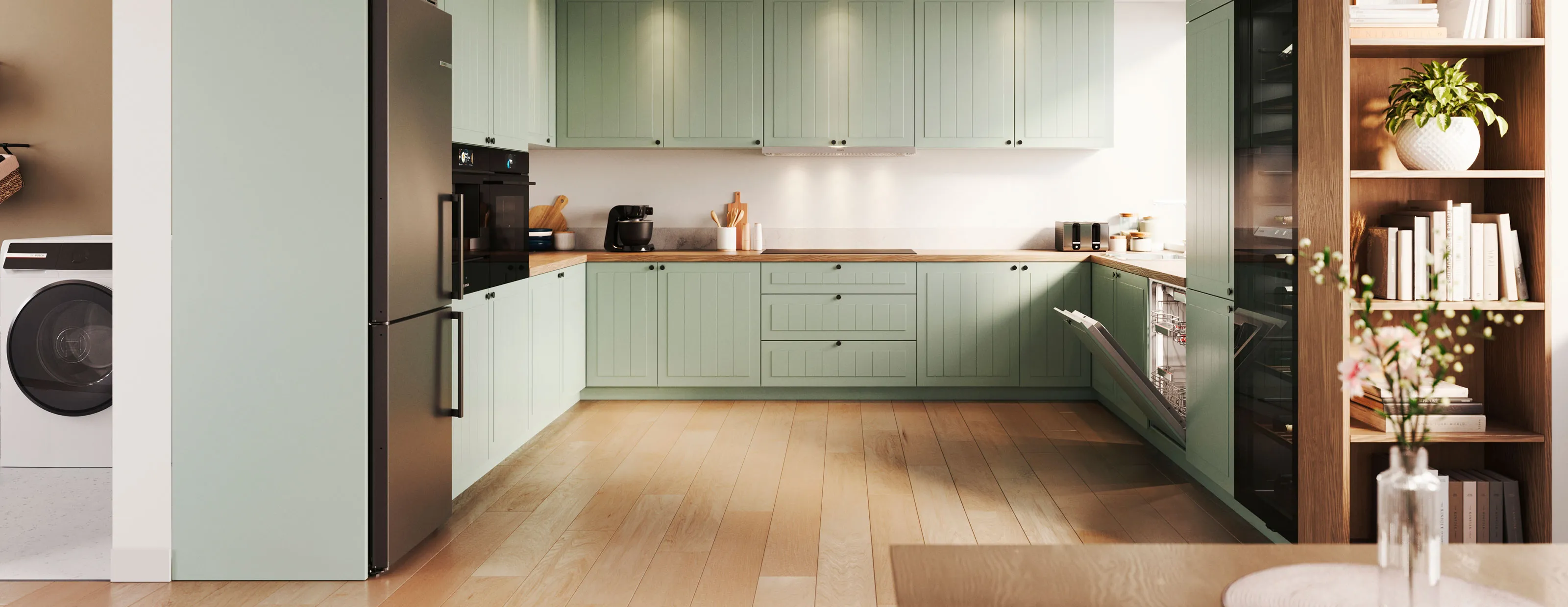 Bilden visar ett grönt Ikea-inspirerat kök med Bosch vitvaror.