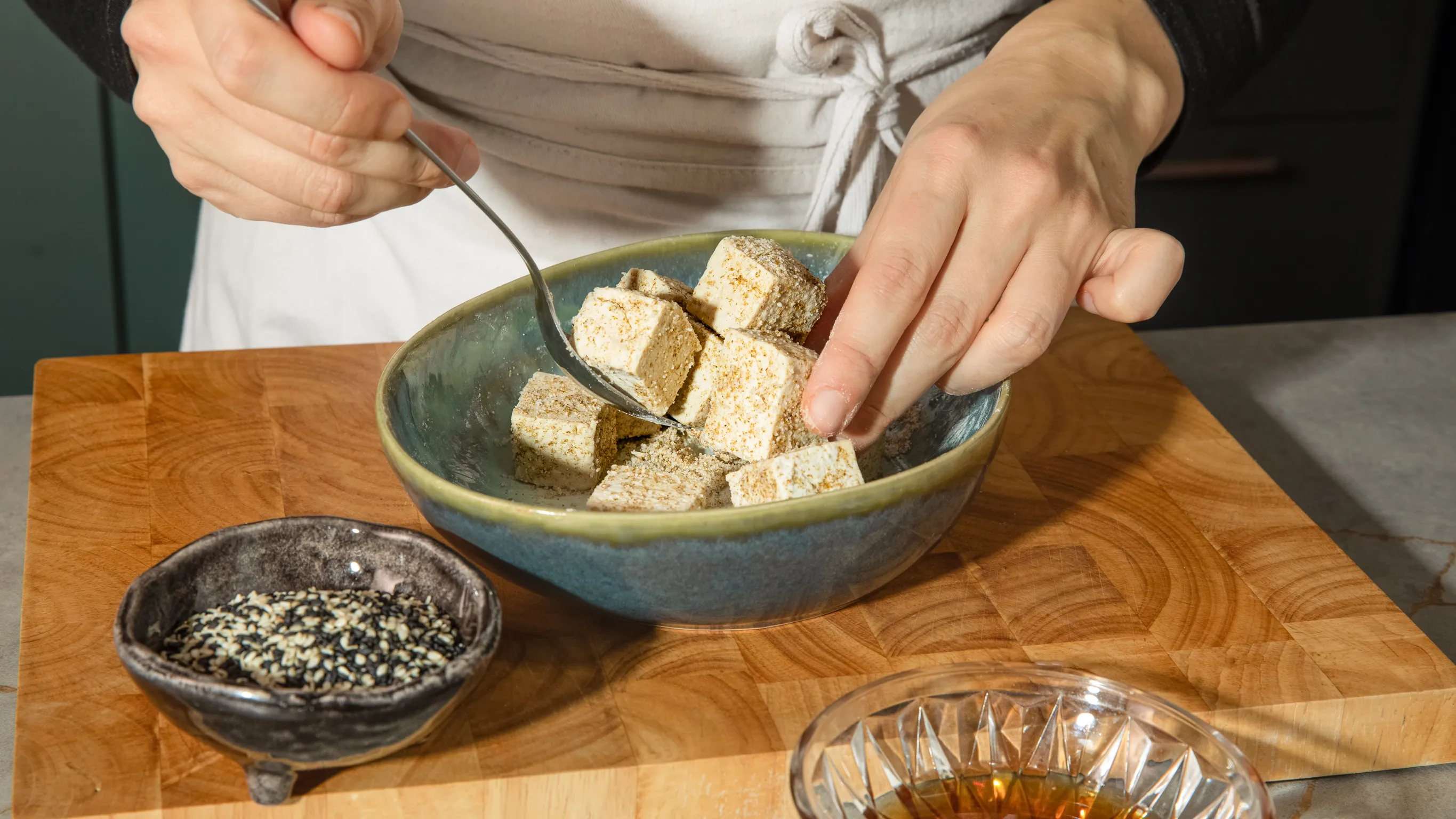 Tossing the tofu in cornstarch