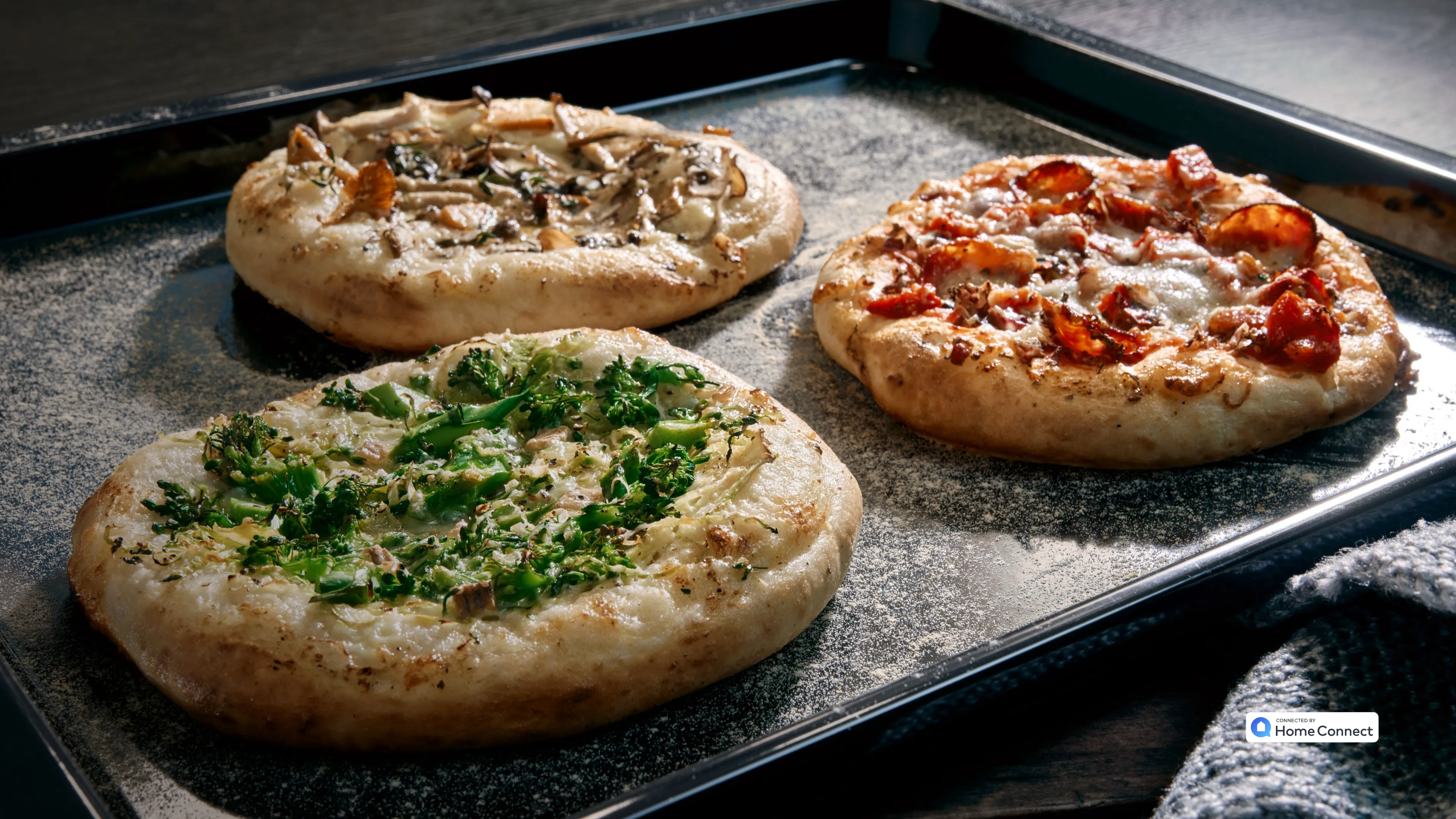 Pizzas cooking on baking tray