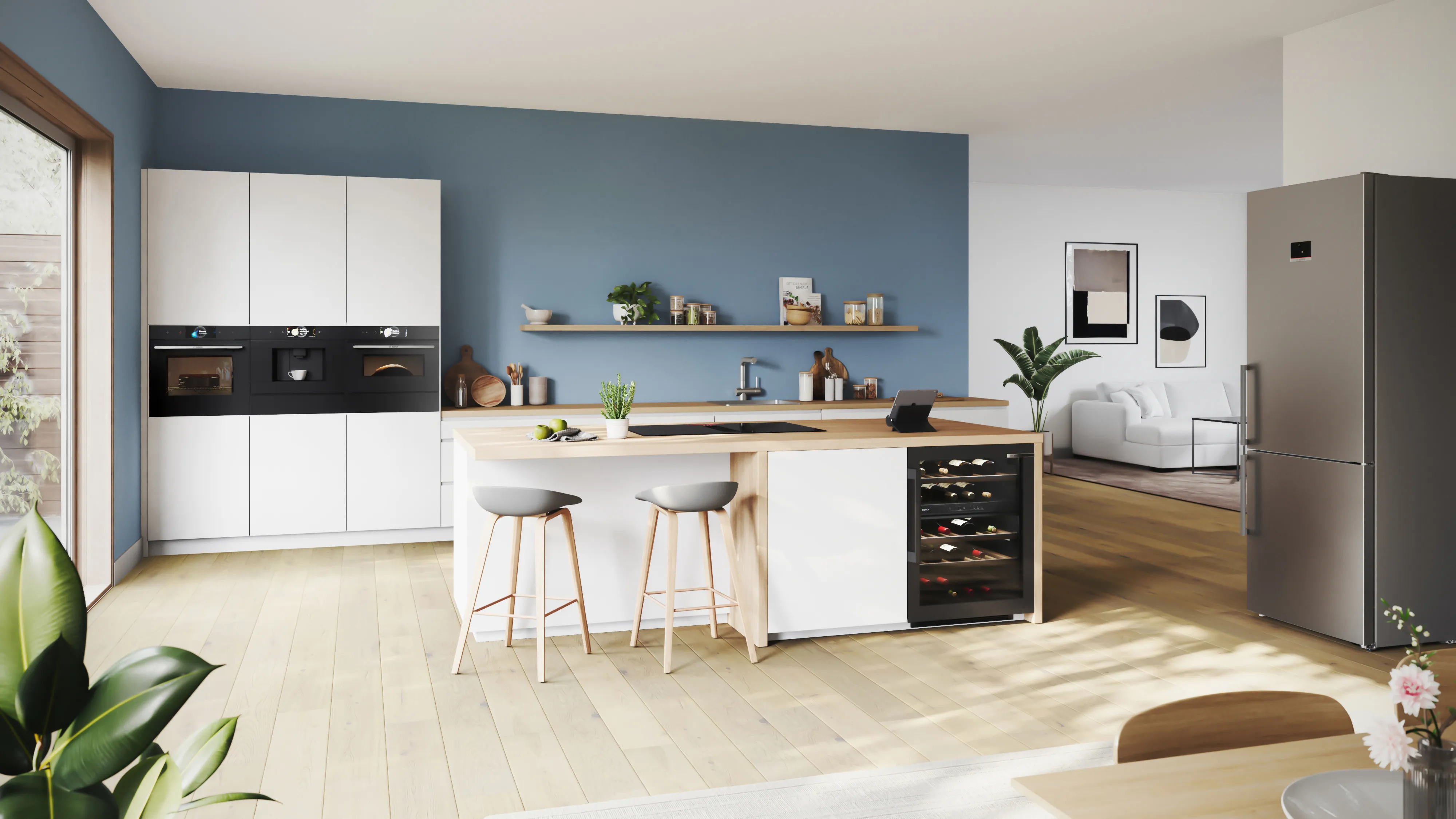 Modern, open-plan kitchen with white cabinets, white island, black and stainless steel appliances.