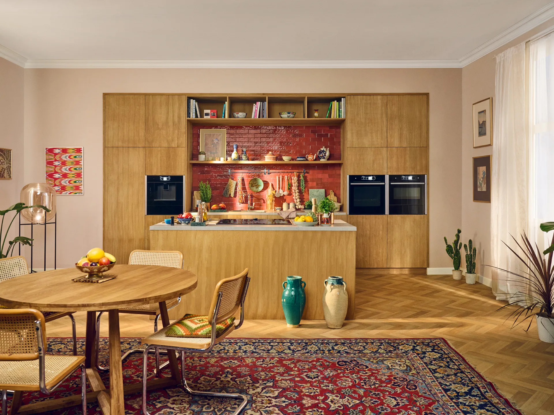 Cozy living room with wooden shelves, dining table, and colorful rug.