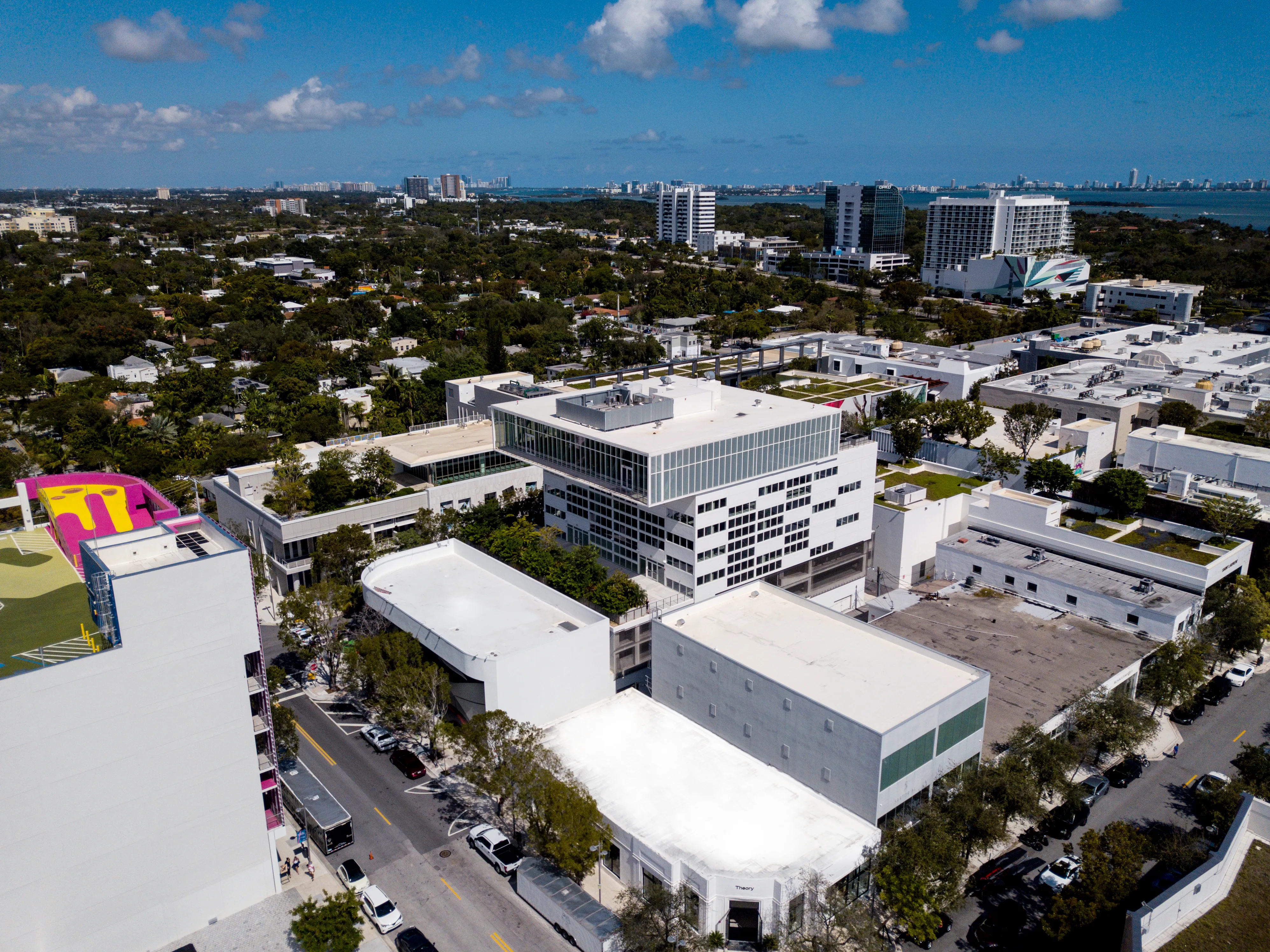 Aerial view of a cityscape with Bosch building, other buildings and trees under a clear blue sky.