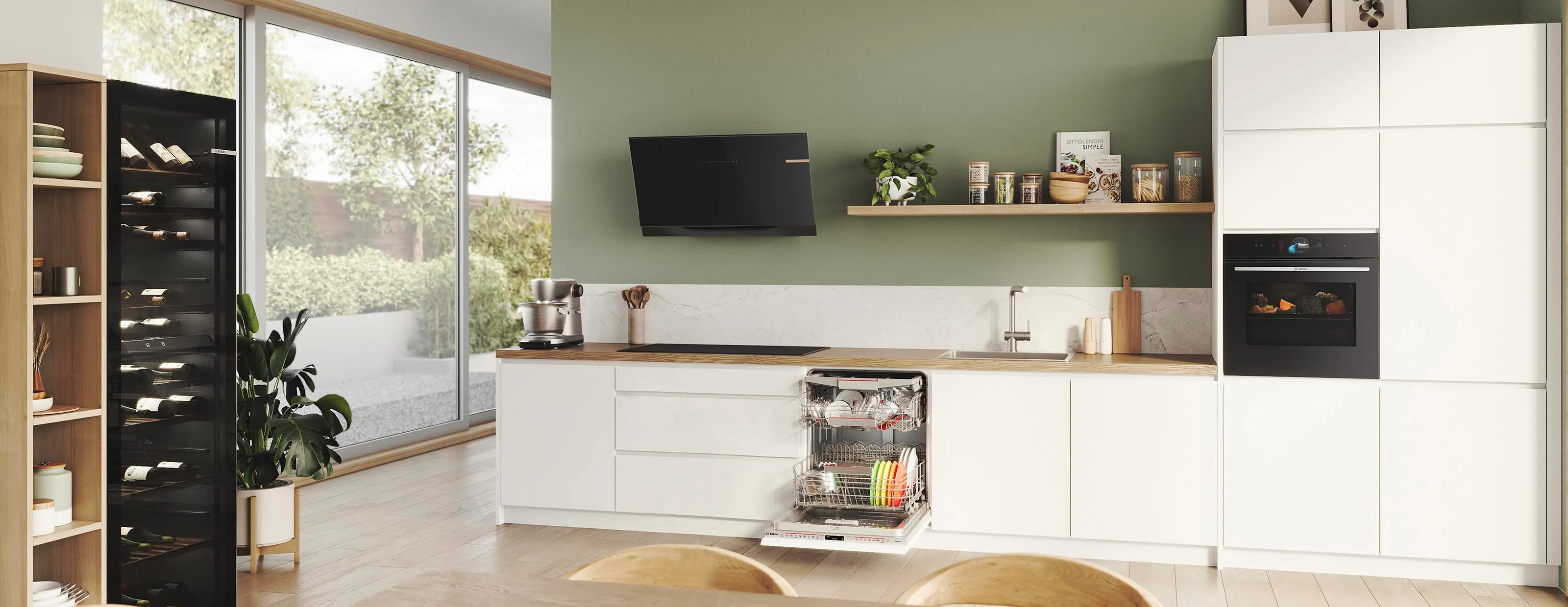 Modern kitchen with white cabinets, wooden countertops, appliances, and large window overlooking outdoor scenery.
