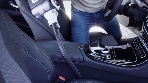 Using vacuum attachments to clean between car seats
