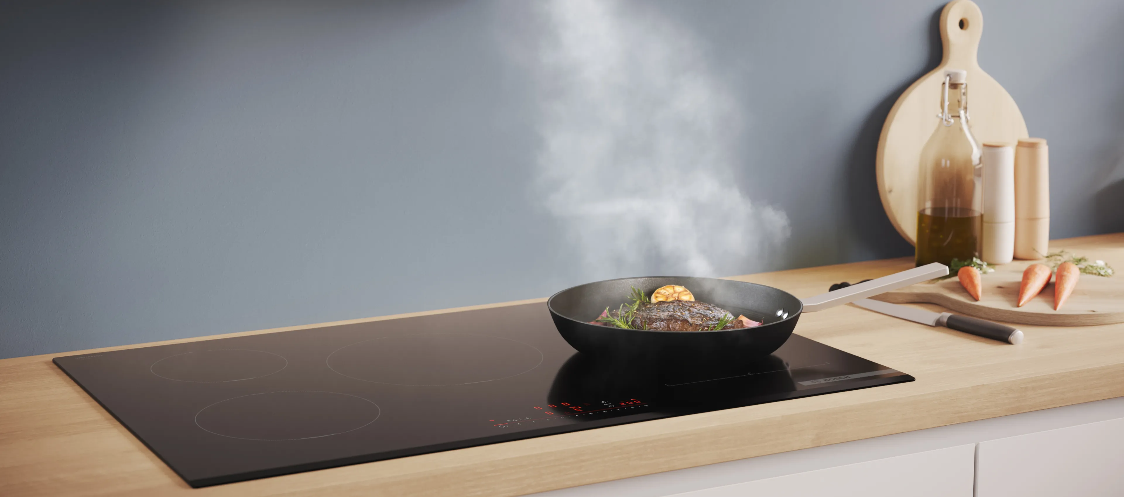 Modern kitchen with a Bosch built-in oven, minimalist wooden cabinetry, and wide induction hob on the island.