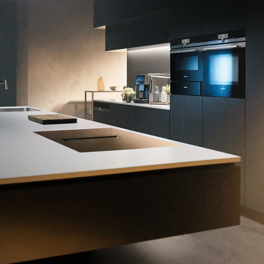 Siemens kitchen with a large table, oven and coffee machine