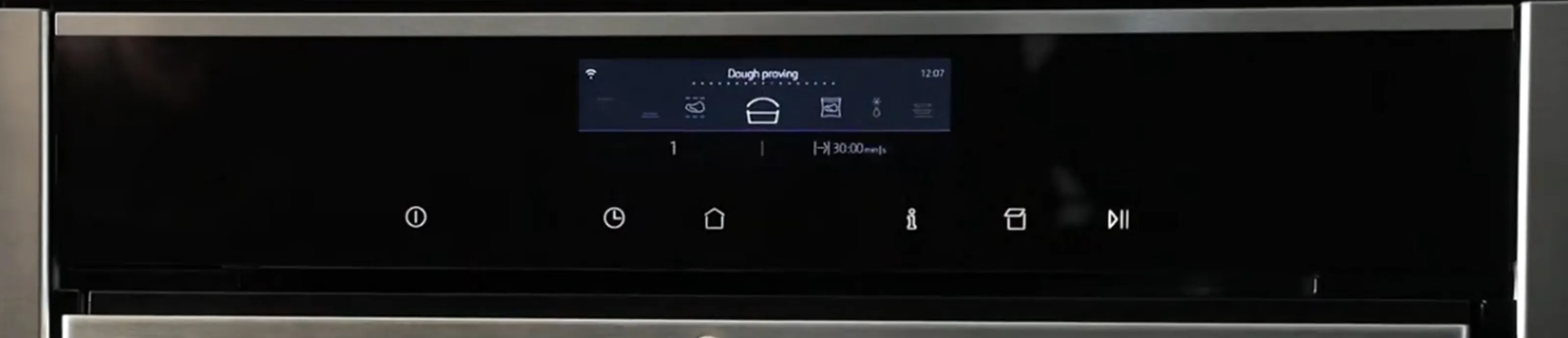 Sleek black oven control panel with digital display, buttons, and knobs for temperature and cooking settings.