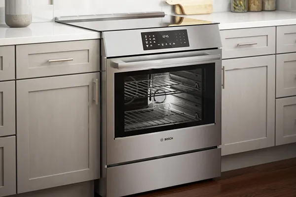 Bosch stainless steel oven with digital controls and glass door integrated into kitchen cabinetry.