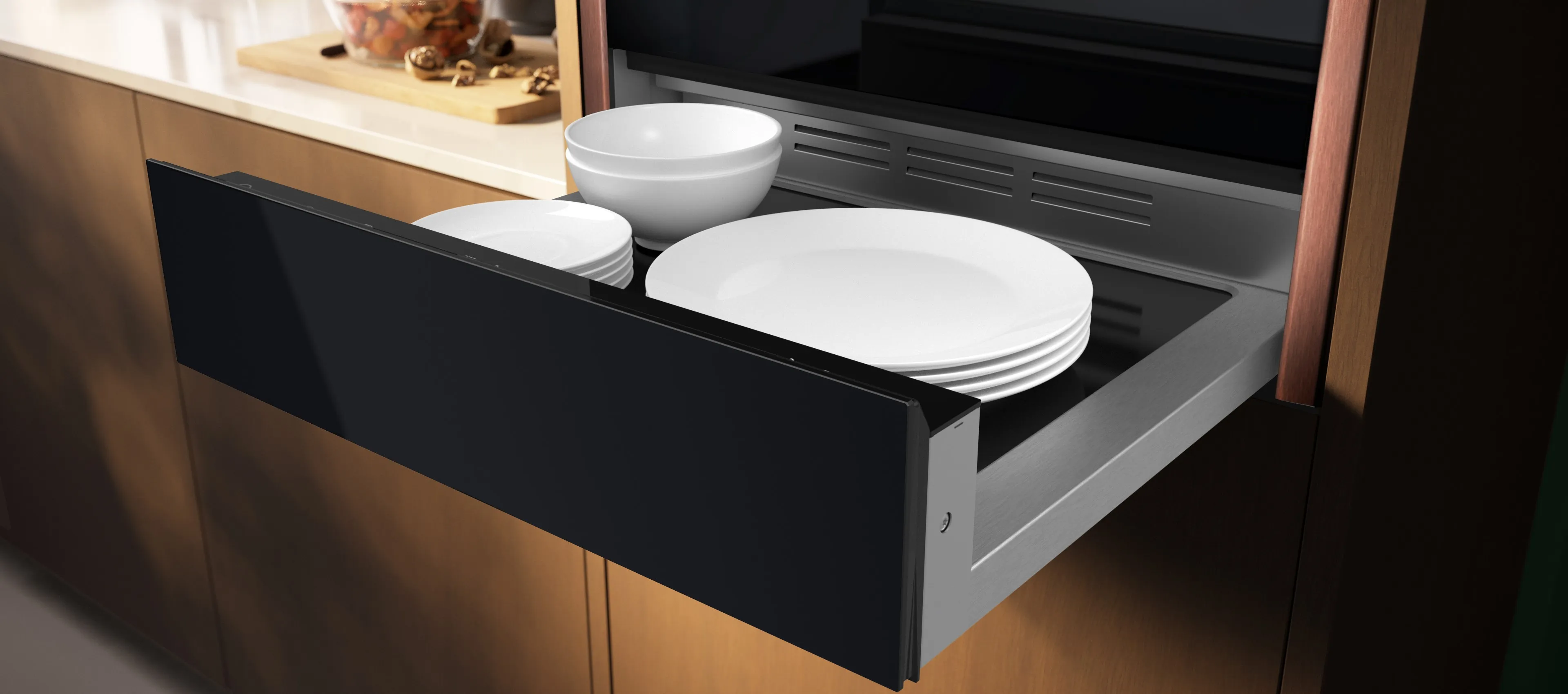 A kitchen drawer filled with neatly arranged dishes and cups of various sizes and colors.  