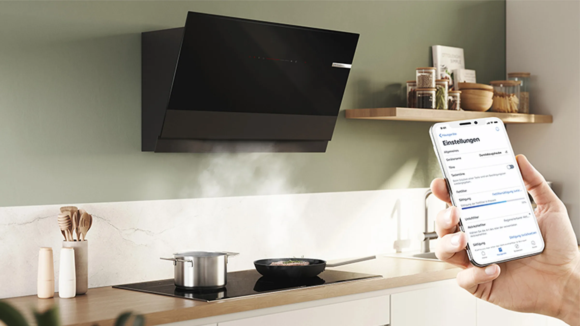 Kitchen with cooking utensils, shelves, and a smartphone displaying an app interface.