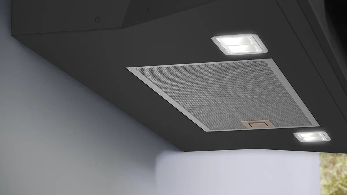 The underside of a Bosch black cooker hood, highlighting its metal grease filter and illuminated LED downlights.