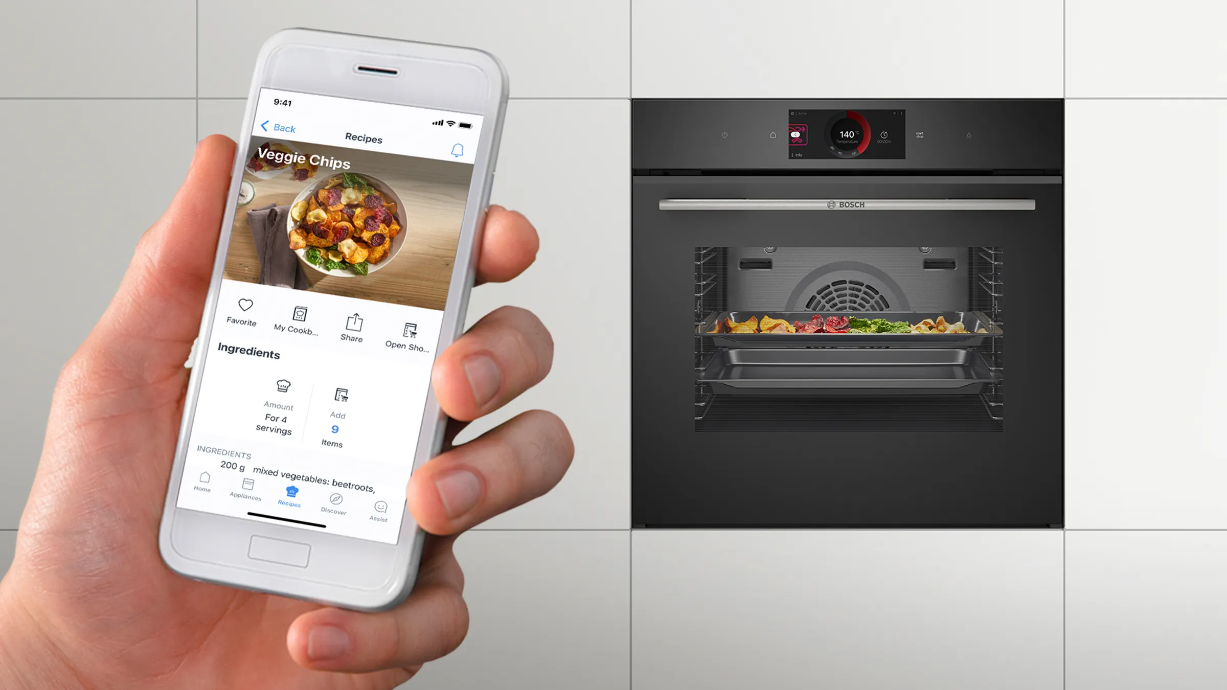 A smartphone displaying a recipe in front of a Bosch smart built-in oven baking colourful veggie chips.