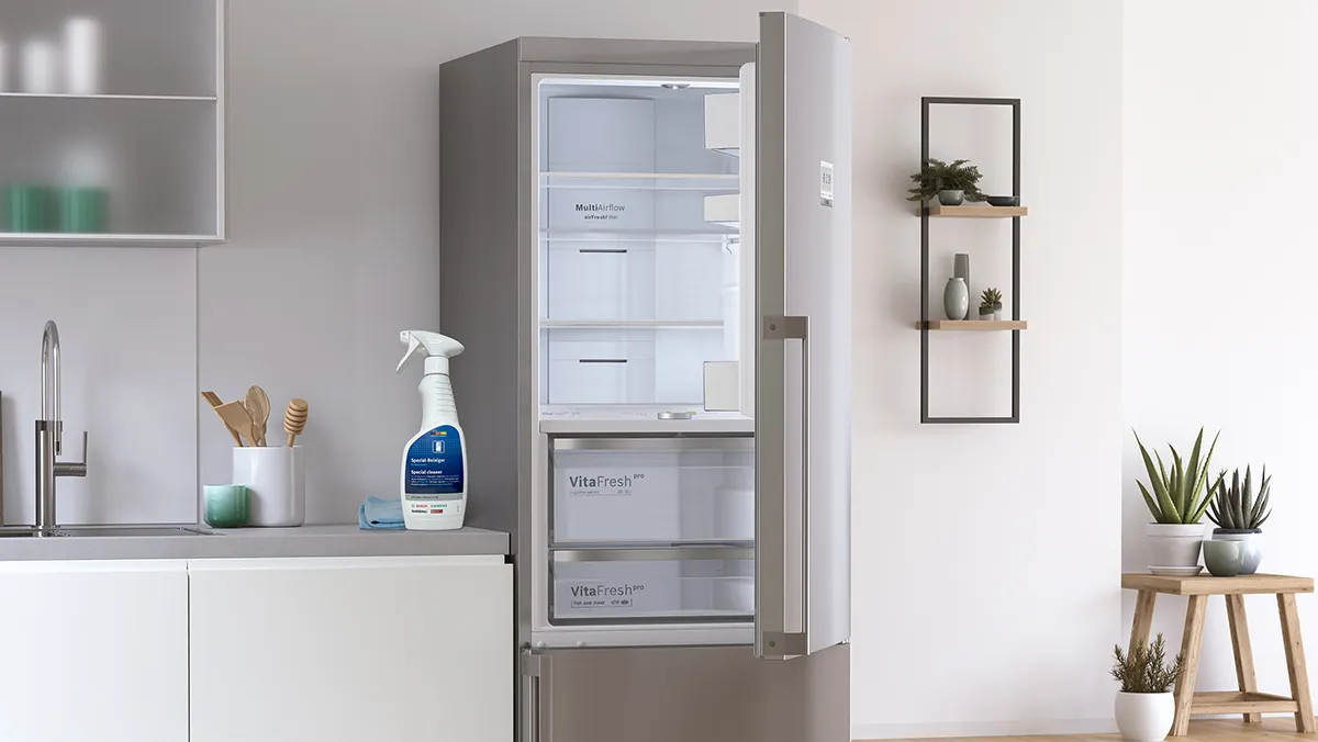 A clean and empty Bosch fridge-freezer in a modern kitchen, illustrating the ease of maintaining and cleaning the appliance.