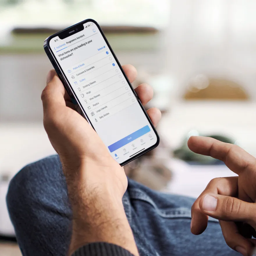 Person mit Smartphone, die mobile App-Schnittstelle zeigt.